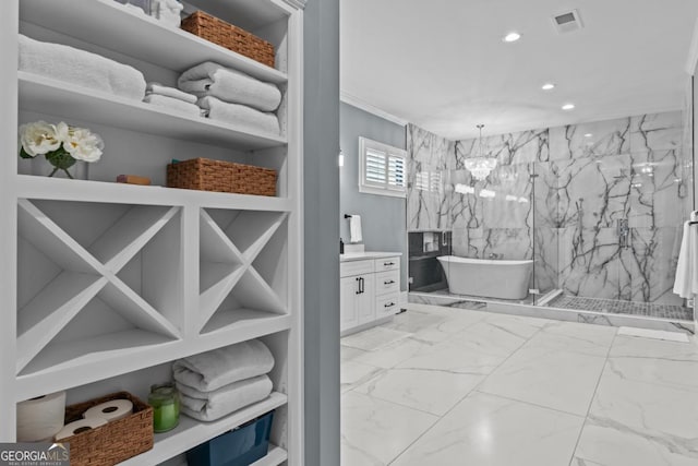 bathroom with an inviting chandelier, vanity, and independent shower and bath