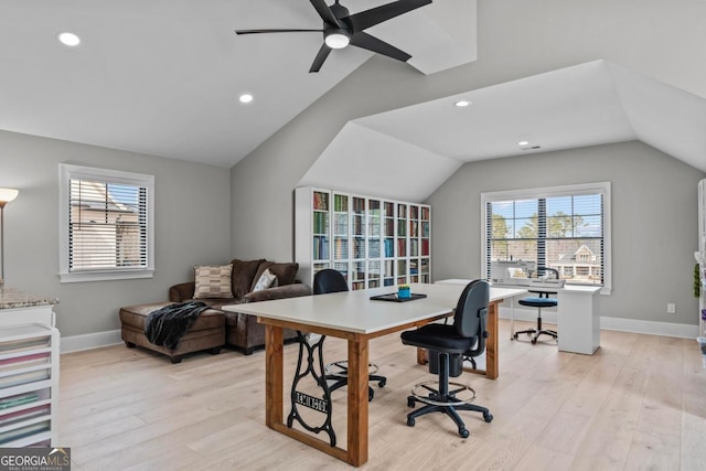 office space with vaulted ceiling, a wealth of natural light, and light wood-type flooring