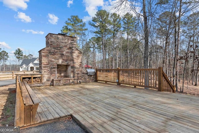 deck featuring an outdoor stone fireplace