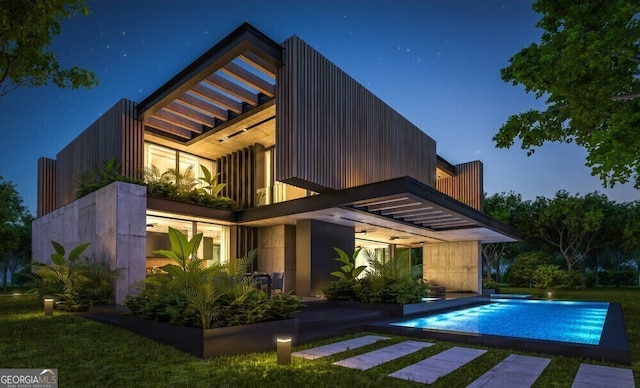 back of property with a balcony, a patio area, and an outdoor pool