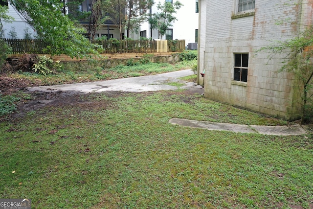 view of yard with fence and cooling unit