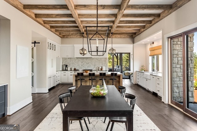 dining area with a barn door, coffered ceiling, baseboards, dark wood-style floors, and beamed ceiling