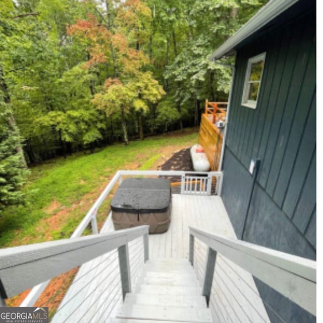 wooden deck featuring a hot tub