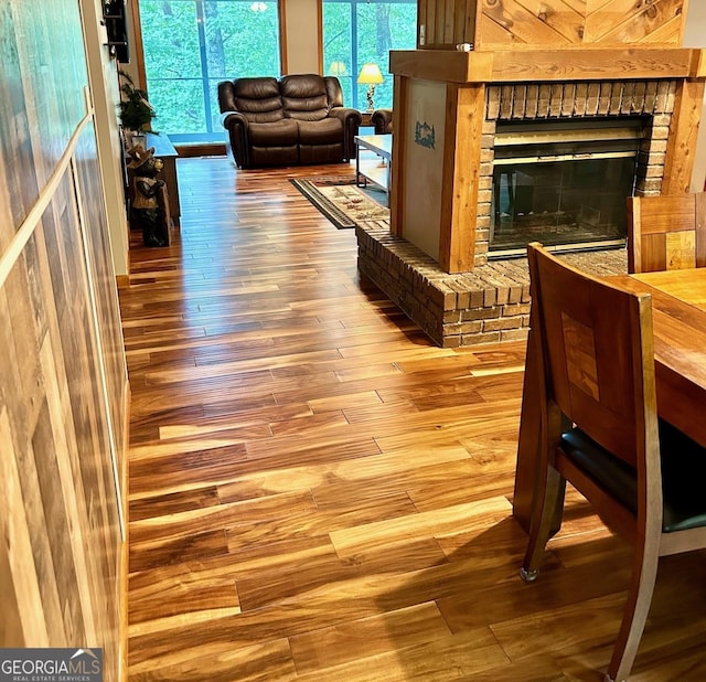 interior space with hardwood / wood-style flooring and a brick fireplace