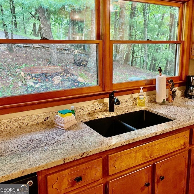 interior details with light stone countertops and sink