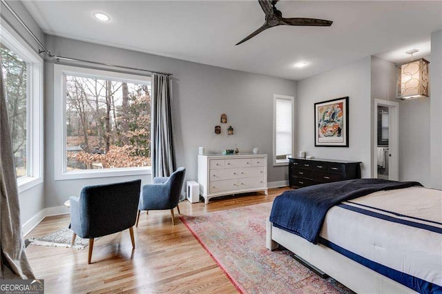 bedroom featuring multiple windows, ceiling fan, and light hardwood / wood-style floors