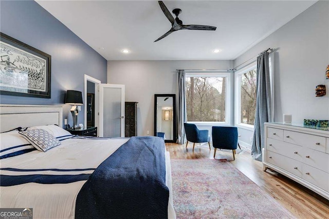 bedroom with light hardwood / wood-style floors and ceiling fan