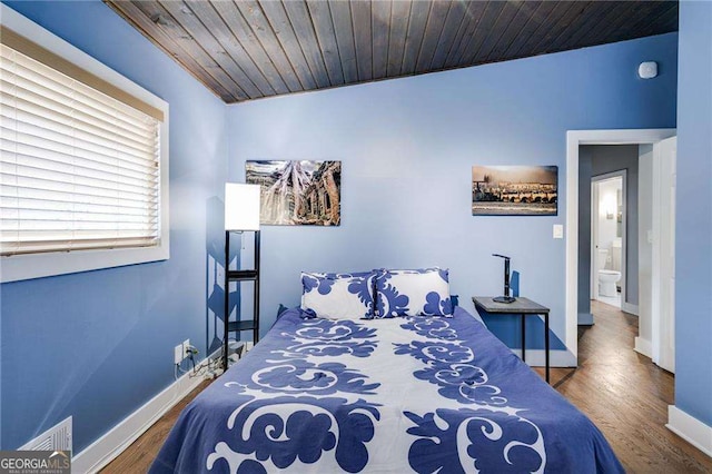 bedroom with wood ceiling and hardwood / wood-style floors