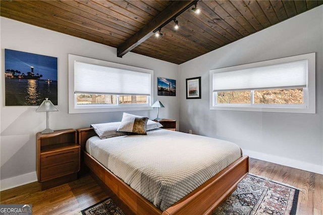 bedroom with multiple windows, dark hardwood / wood-style floors, vaulted ceiling with beams, and wooden ceiling