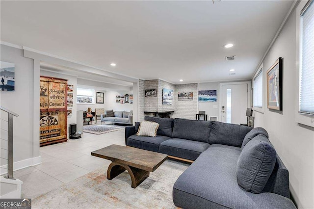 living room with a multi sided fireplace and light tile patterned floors