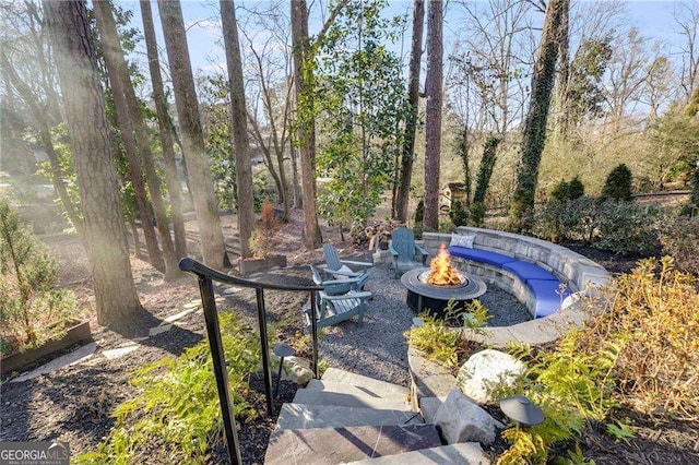 view of yard featuring an outdoor fire pit