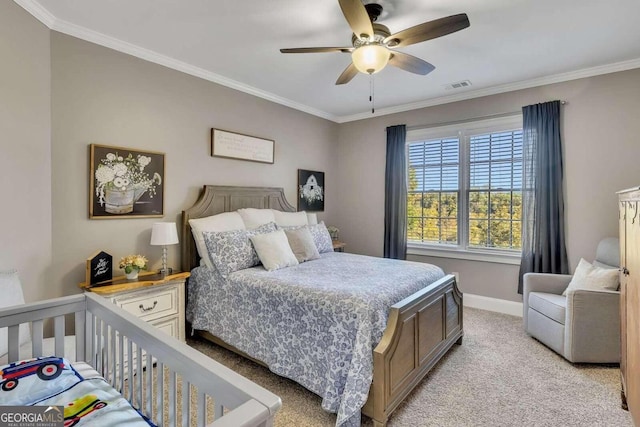 carpeted bedroom featuring ceiling fan and ornamental molding