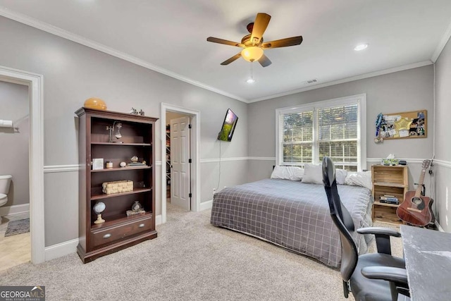 carpeted bedroom featuring crown molding, ceiling fan, and a spacious closet