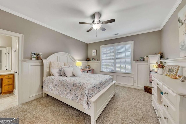 bedroom featuring ornamental molding, light carpet, and ceiling fan