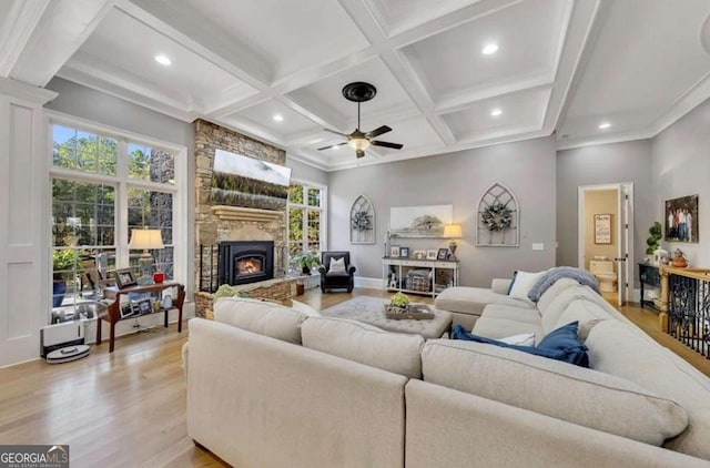 living room with ceiling fan, coffered ceiling, light hardwood / wood-style floors, and a wealth of natural light