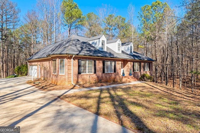 view of home's exterior with a garage and a yard