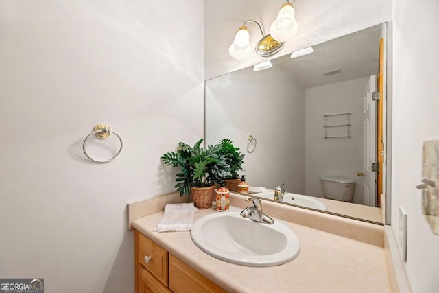 bathroom with vanity and toilet