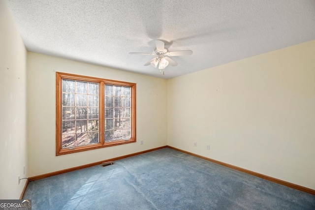 empty room with carpet flooring, a textured ceiling, and ceiling fan