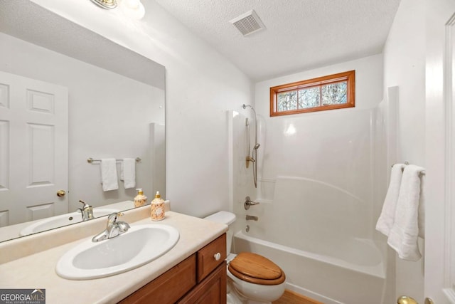 full bathroom with vanity, shower / bathing tub combination, a textured ceiling, and toilet