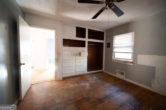 unfurnished bedroom with a closet, ceiling fan, hardwood / wood-style floors, and a textured ceiling