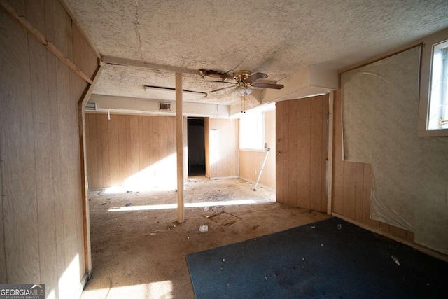 spare room featuring ceiling fan and plenty of natural light