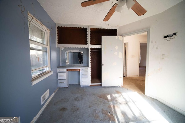 unfurnished bedroom featuring a textured ceiling and ceiling fan