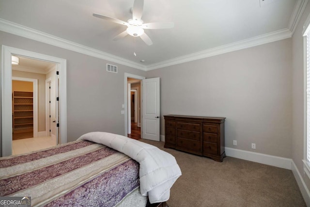 carpeted bedroom with crown molding and ceiling fan