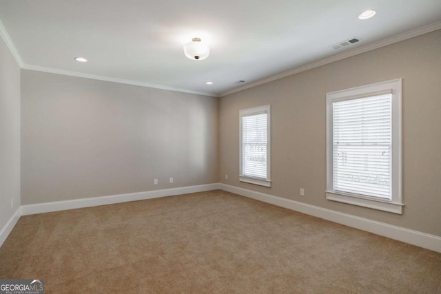 carpeted spare room featuring crown molding