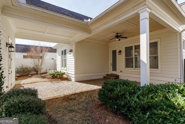 property entrance with a patio area and ceiling fan