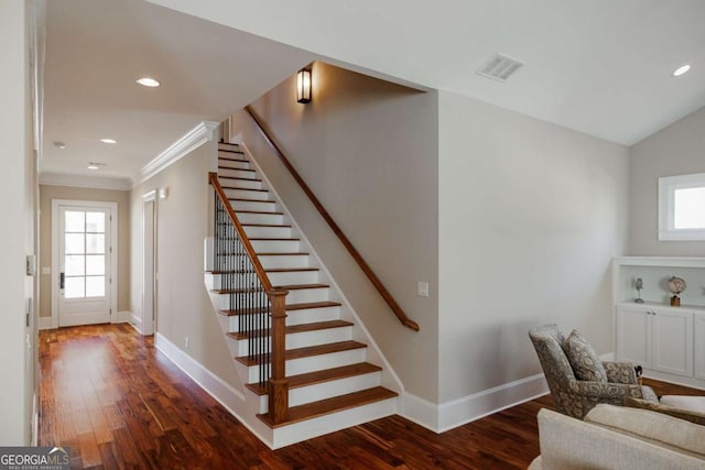 stairway with hardwood / wood-style flooring, ornamental molding, and plenty of natural light