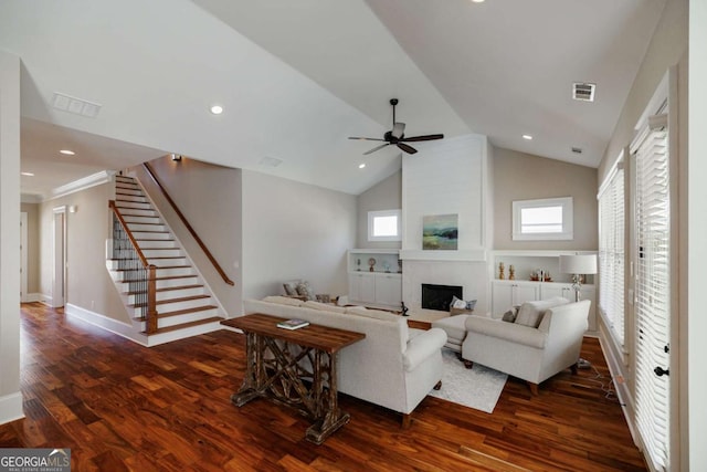 living room with ceiling fan, high vaulted ceiling, dark wood-type flooring, and a fireplace