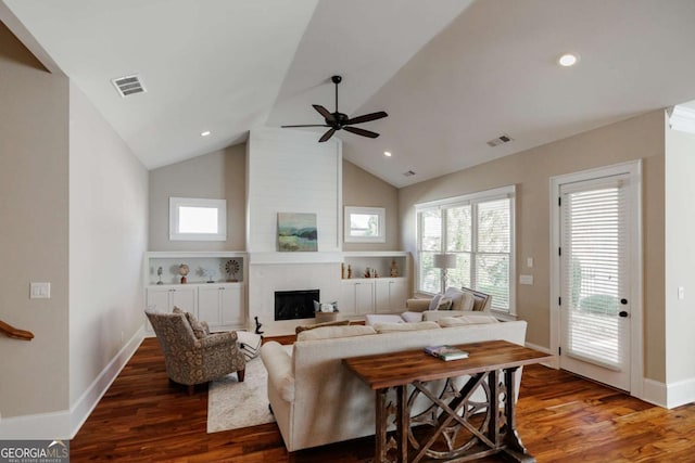 living room featuring a fireplace, high vaulted ceiling, dark hardwood / wood-style floors, and ceiling fan