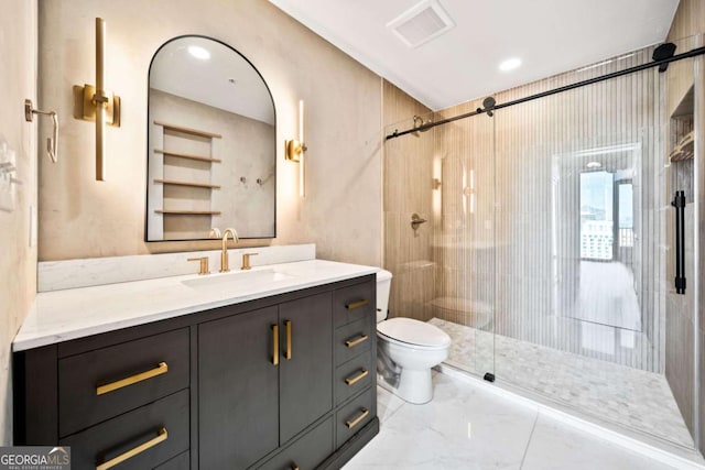 bathroom with vanity, a shower with shower door, and toilet