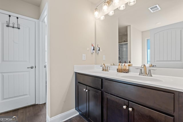 bathroom featuring hardwood / wood-style flooring and vanity