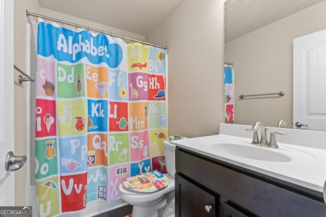 bathroom featuring vanity, toilet, and a shower with shower curtain