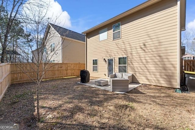 rear view of house featuring an outdoor living space and a patio area