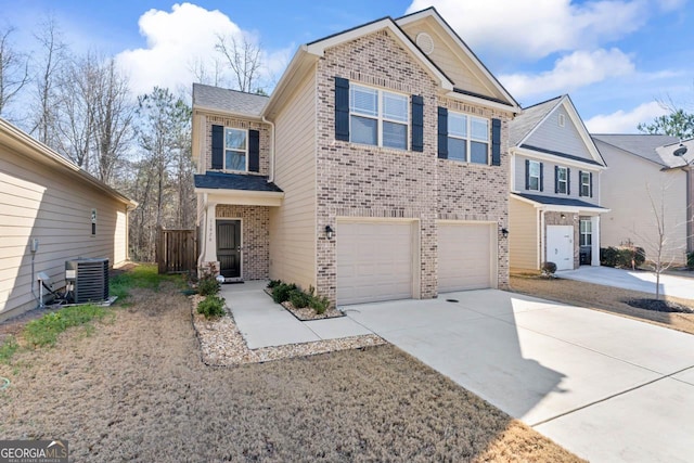 view of front of house featuring a garage and central AC unit