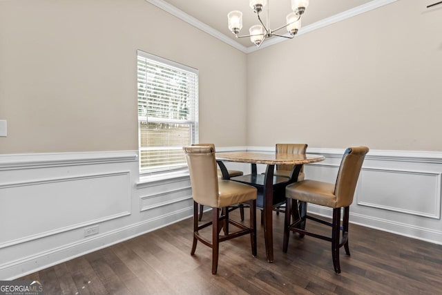 dining room with crown molding, dark hardwood / wood-style flooring, and a chandelier