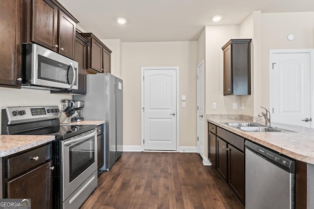 kitchen with dark brown cabinetry, sink, dark hardwood / wood-style floors, and appliances with stainless steel finishes