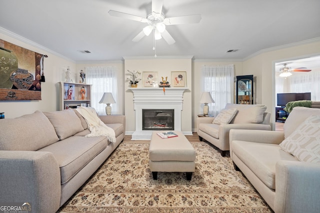 living room featuring hardwood / wood-style flooring, ornamental molding, and ceiling fan