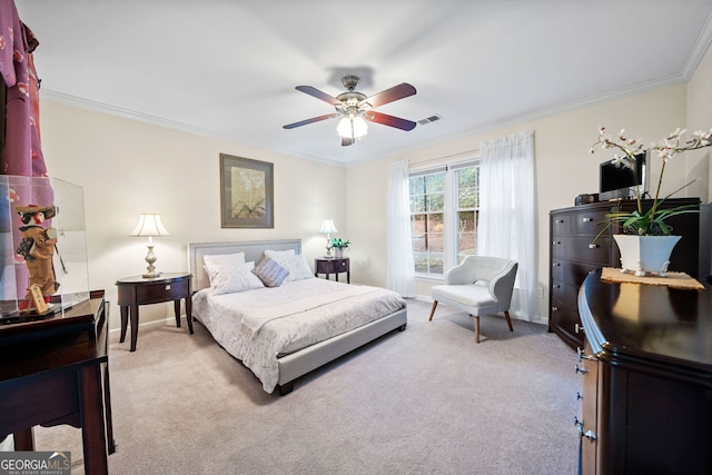 bedroom featuring crown molding, ceiling fan, and carpet