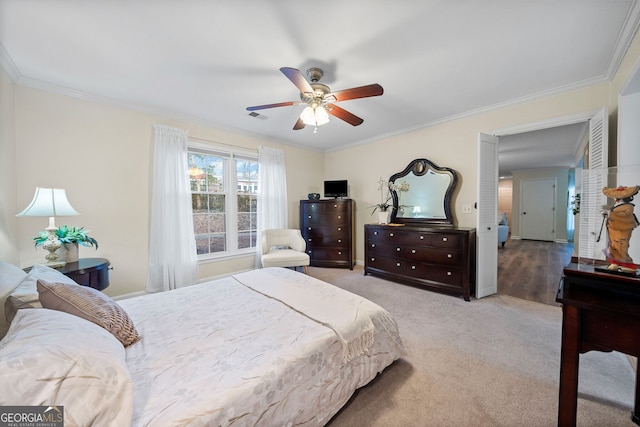 bedroom with ceiling fan, ornamental molding, and light carpet