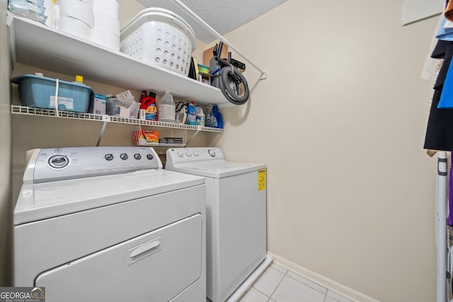 clothes washing area with separate washer and dryer