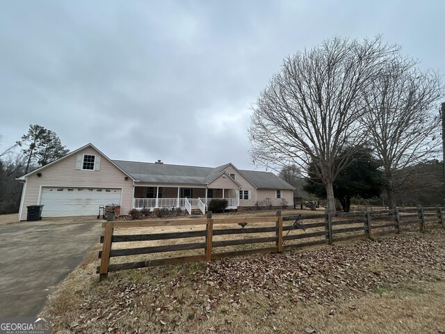 view of front of house featuring a porch and a garage