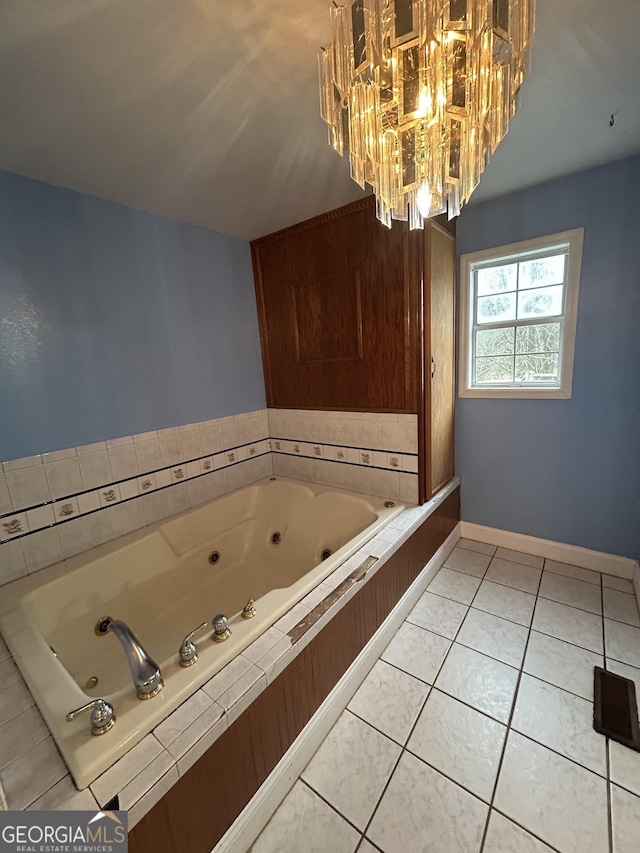 382 Lower Lovelace Rd, West Point, GA 31833 - bathroom featuring a jetted tub, a chandelier, tile patterned flooring, and baseboards
