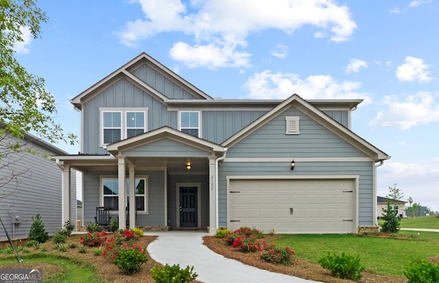 craftsman-style home featuring a garage, a front yard, and covered porch