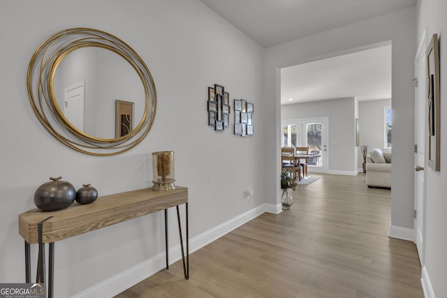 hallway with light hardwood / wood-style floors