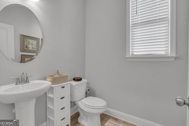 bathroom featuring sink, toilet, and hardwood / wood-style floors