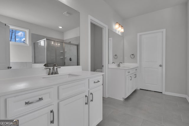 bathroom with vanity, toilet, and walk in shower