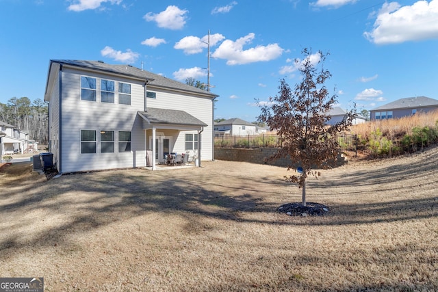 back of property featuring a patio area and a lawn